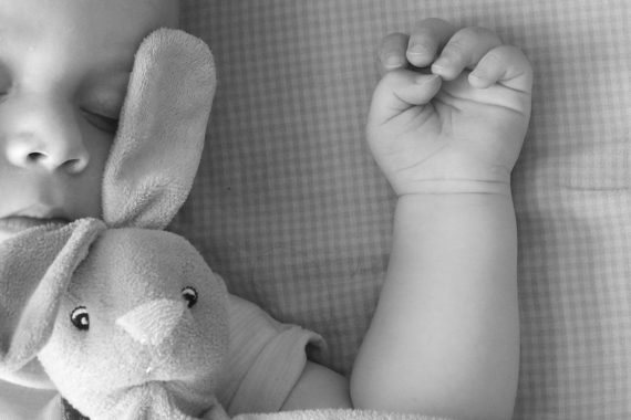 baby sleeping with soft toy